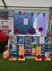 Veteran sat at a stall at the armed forces day event.